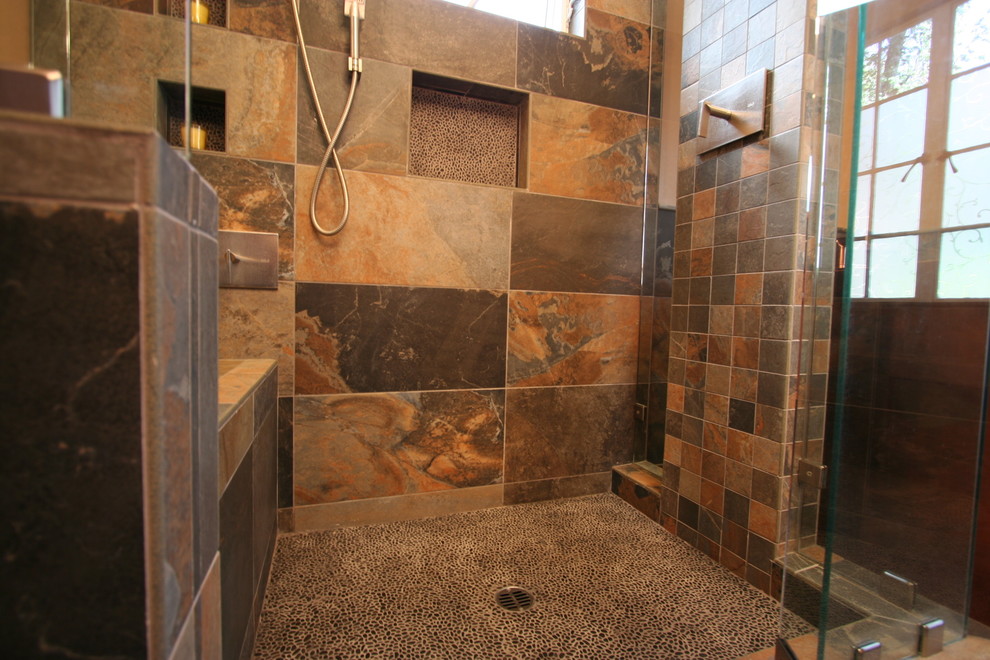 Gray tile and pebble tile bathroom photo in Los Angeles with beige walls