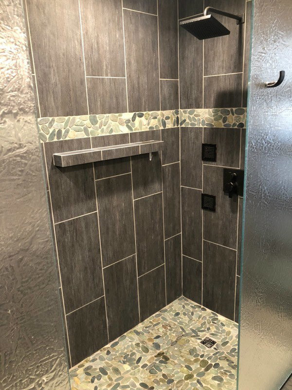 Inspiration for a mid-sized zen master brown tile and porcelain tile ceramic tile and brown floor bathroom remodel in Minneapolis with recessed-panel cabinets, dark wood cabinets, a one-piece toilet, brown walls, an undermount sink and granite countertops
