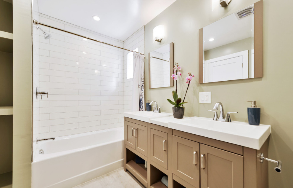 Medium sized classic shower room bathroom in San Francisco with freestanding cabinets, brown cabinets, an alcove bath, a shower/bath combination, white tiles, metro tiles, beige walls, porcelain flooring, an integrated sink, solid surface worktops, beige floors, a shower curtain and white worktops.