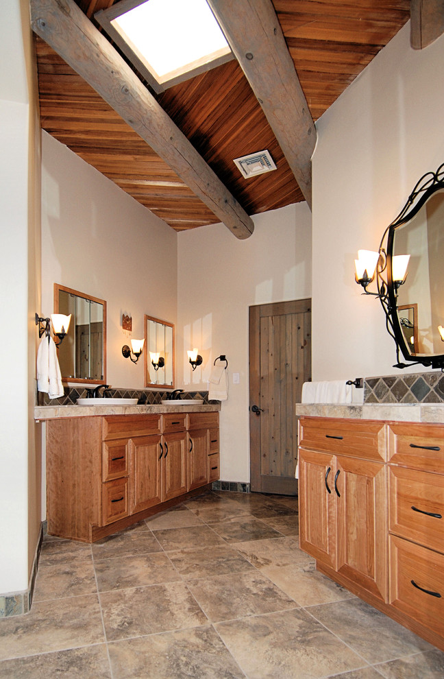 Medium sized rustic ensuite bathroom in Portland with raised-panel cabinets, medium wood cabinets, a built-in bath, a corner shower, a one-piece toilet, slate tiles, white walls, a built-in sink and a hinged door.