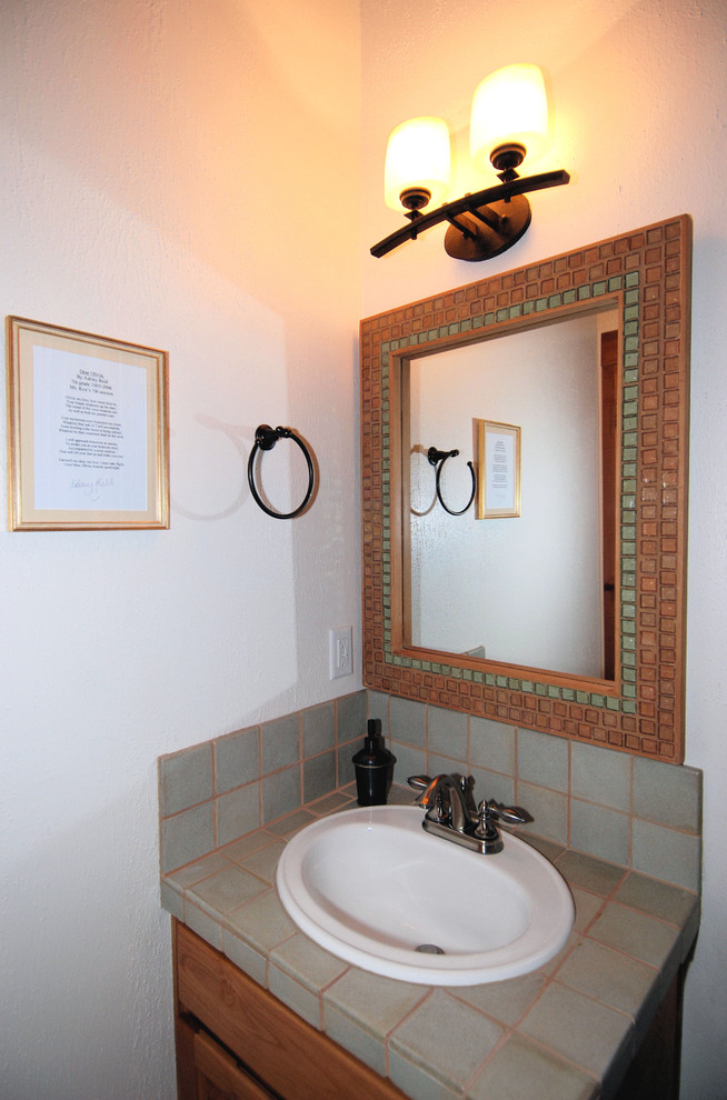 Bathroom - small asian 3/4 gray tile bathroom idea in Portland with flat-panel cabinets, medium tone wood cabinets, a drop-in sink, a one-piece toilet, white walls and tile countertops