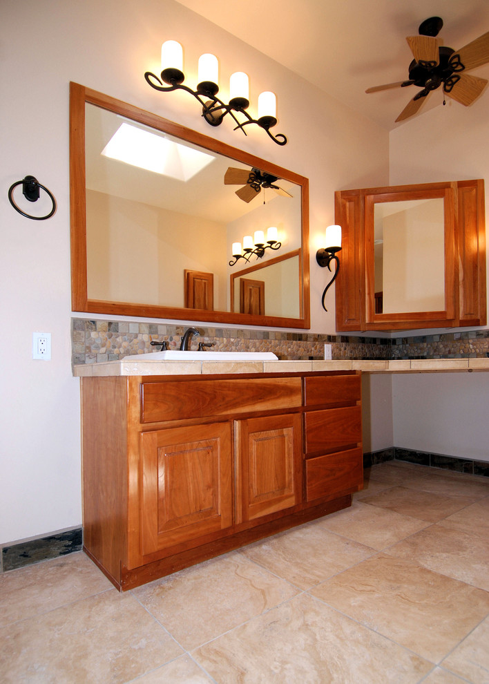 Photo of a medium sized traditional ensuite bathroom in Portland with raised-panel cabinets, medium wood cabinets, white walls and a built-in sink.