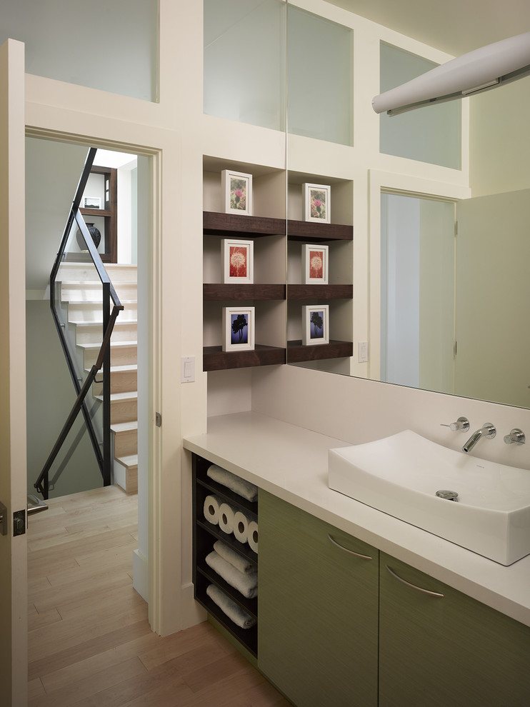 Example of a mid-sized minimalist medium tone wood floor and beige floor bathroom design in San Francisco with a vessel sink, green cabinets, white walls and quartzite countertops