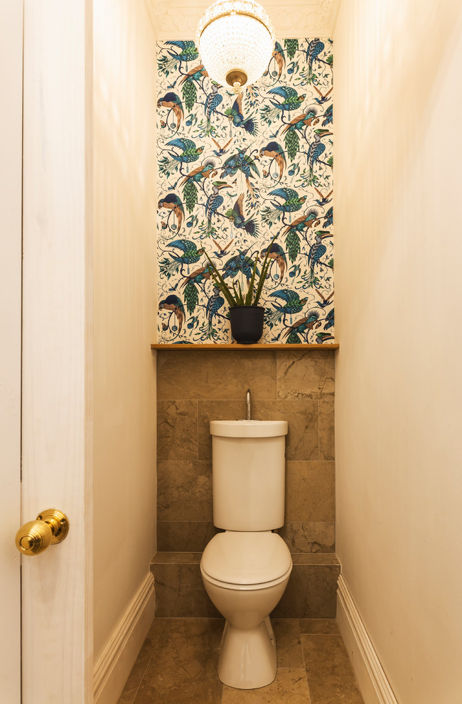 Example of a small transitional marble tile powder room design in Manchester