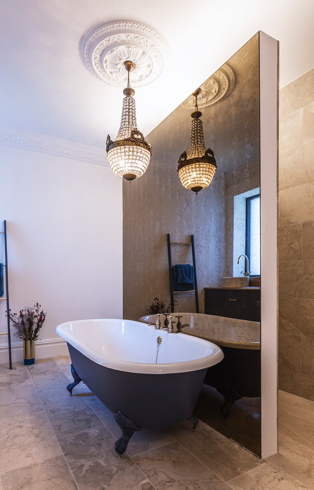 This is an example of a classic bathroom in Manchester with blue cabinets, a claw-foot bath, a built-in shower, porcelain tiles, white walls, marble flooring, wooden worktops and an open shower.