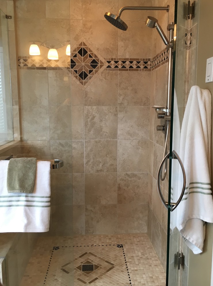 Photo of a medium sized classic ensuite bathroom in Atlanta with freestanding cabinets, black cabinets, a freestanding bath, a corner shower, beige tiles, stone tiles, beige walls, porcelain flooring, a vessel sink and marble worktops.