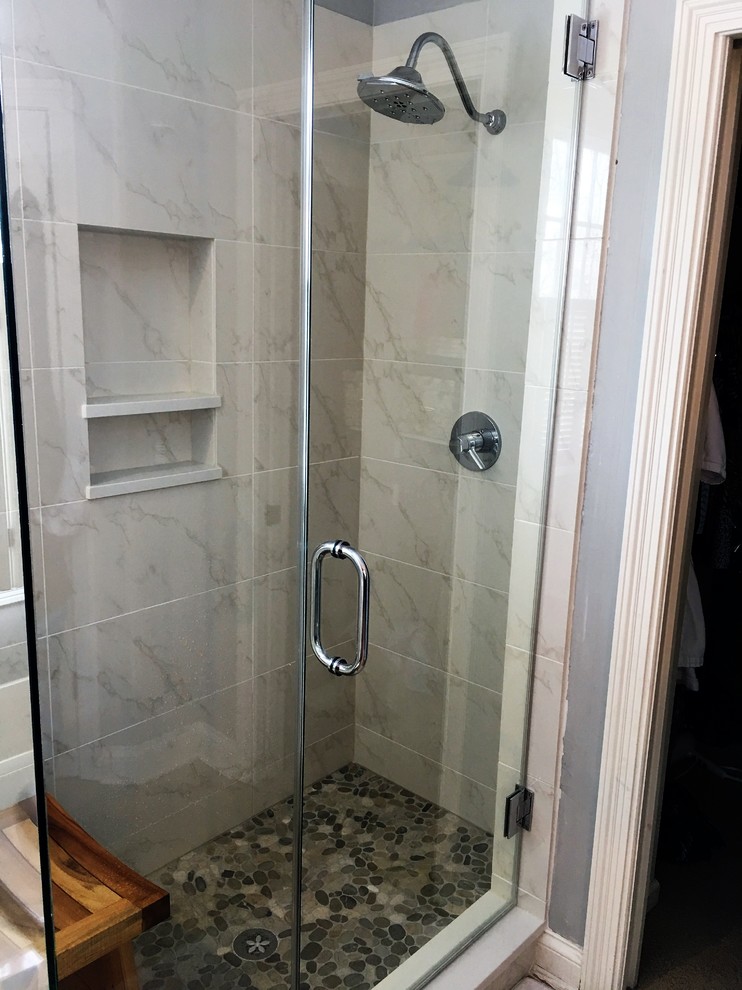 Photo of a medium sized contemporary shower room bathroom in Indianapolis with an alcove shower, grey tiles, marble tiles, grey walls and a hinged door.