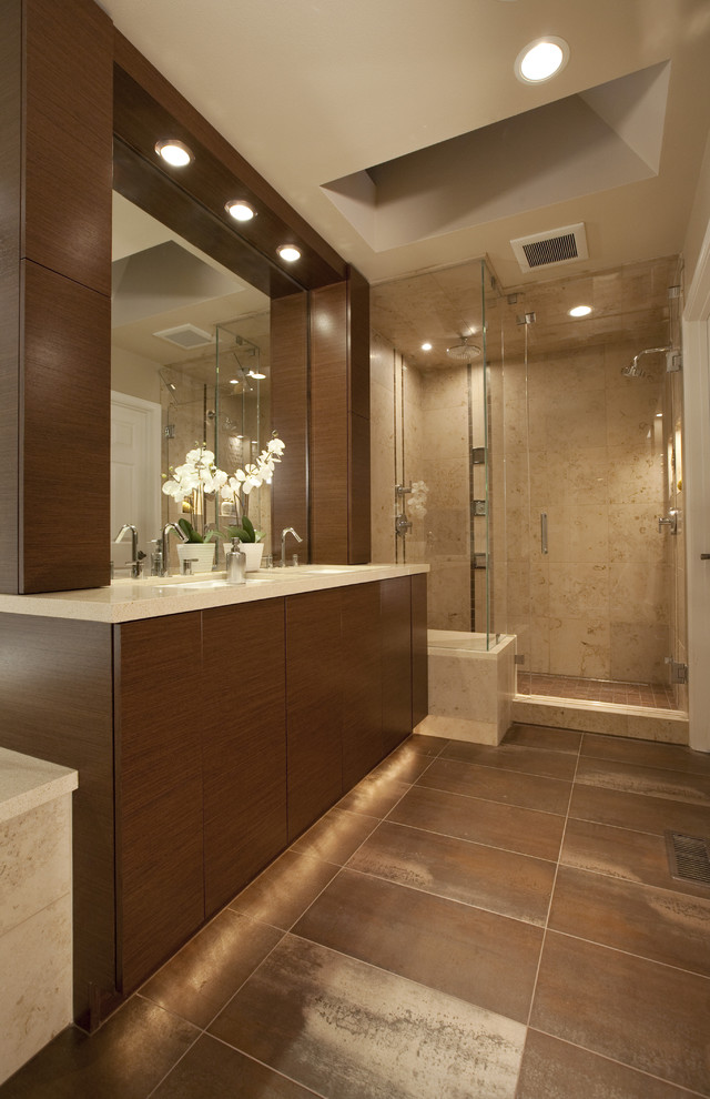 Alcove shower - large contemporary master brown tile and travertine tile concrete floor and brown floor alcove shower idea in Seattle with flat-panel cabinets, brown cabinets, an undermount sink, quartz countertops and a hinged shower door