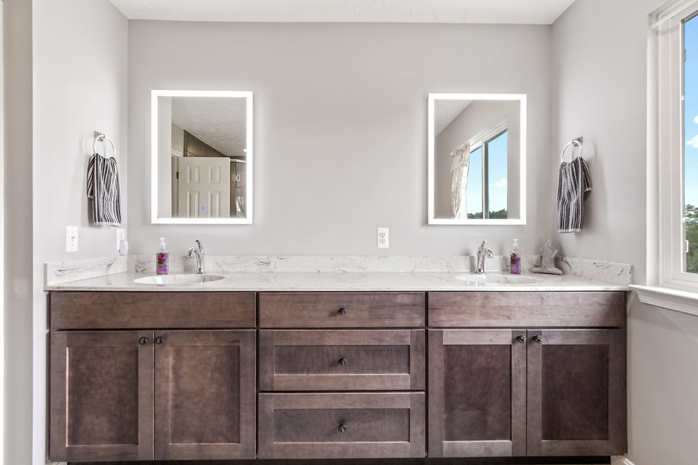 Example of a mid-sized transitional master gray tile and stone tile gray floor bathroom design in Other with shaker cabinets, gray cabinets, a two-piece toilet, an integrated sink, terrazzo countertops, a hinged shower door and multicolored countertops