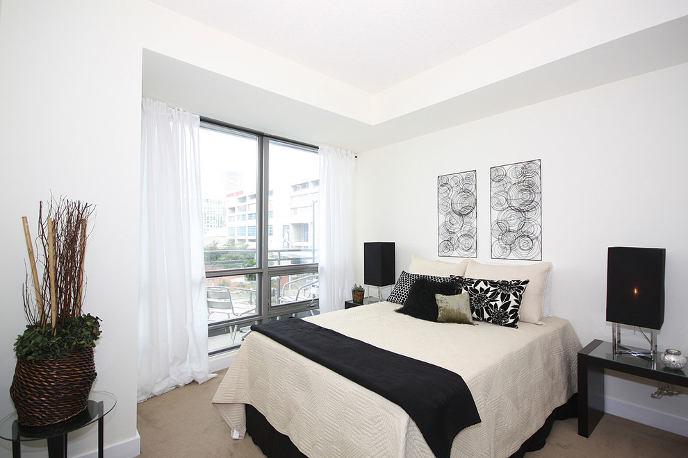 Small minimalist master carpeted bedroom photo in Toronto with beige walls and no fireplace