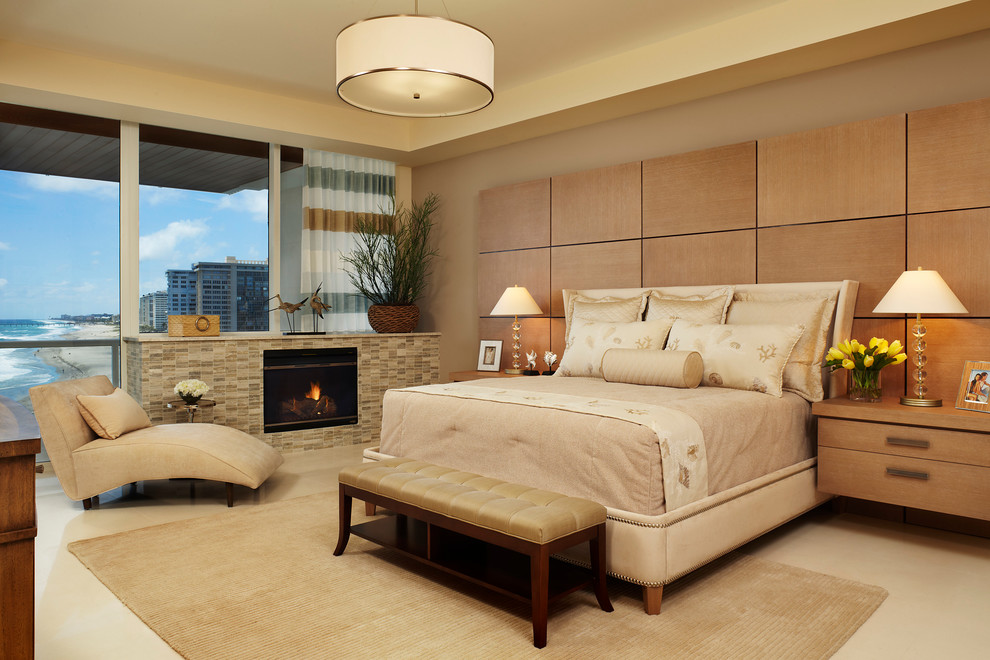 Photo of a contemporary bedroom in Miami with beige walls and a standard fireplace.
