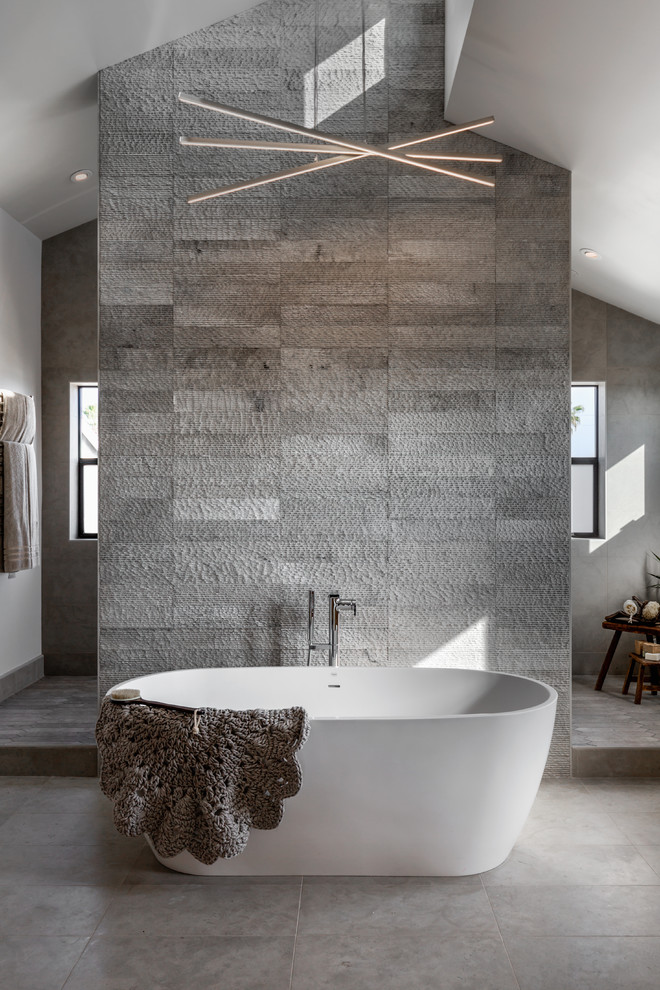 This is an example of a contemporary bathroom in Orange County with white walls and grey floors.