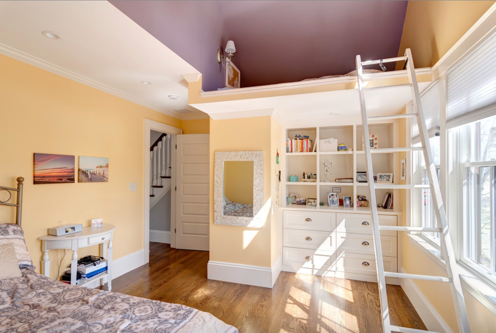 Example of a large transitional guest medium tone wood floor bedroom design in Boston with yellow walls