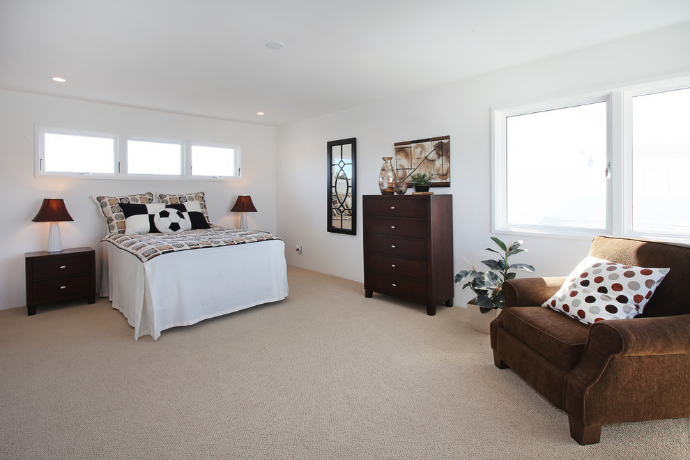 Example of an island style bedroom design in Orange County