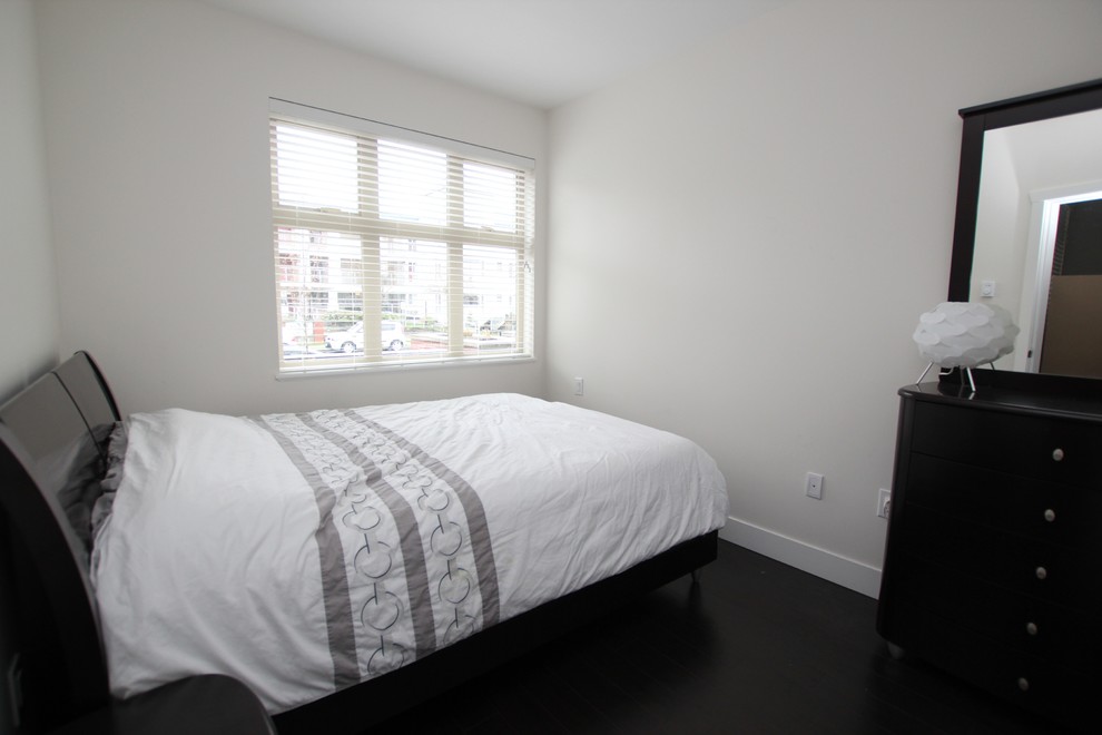 Inspiration for a modern master laminate floor bedroom remodel in Vancouver
