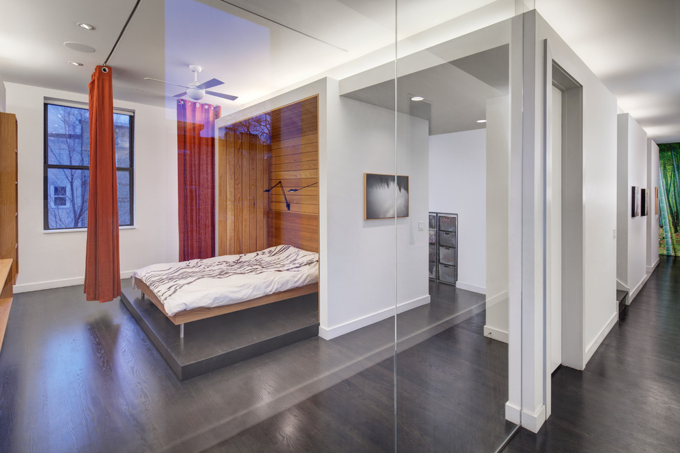 Photo of a large contemporary master bedroom in Chicago with white walls, dark hardwood flooring, no fireplace and brown floors.
