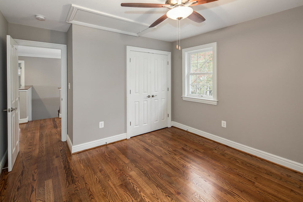 Photo of a contemporary guest bedroom in DC Metro with grey walls, medium hardwood flooring and no fireplace.