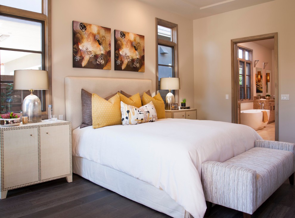 Example of a trendy dark wood floor bedroom design in San Diego with beige walls