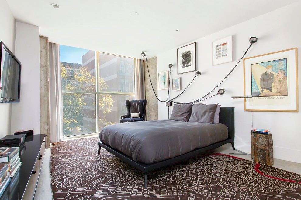 Example of a large urban master light wood floor bedroom design in New York with white walls and no fireplace