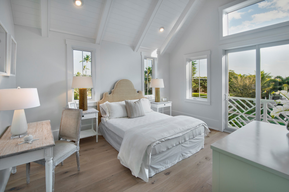 Inspiration for a coastal light wood floor and beige floor bedroom remodel in Other with white walls and no fireplace