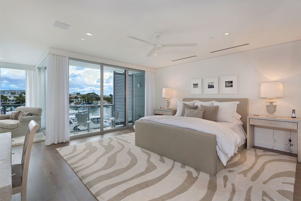 Geräumiges Modernes Hauptschlafzimmer ohne Kamin mit weißer Wandfarbe, braunem Holzboden und braunem Boden in Miami