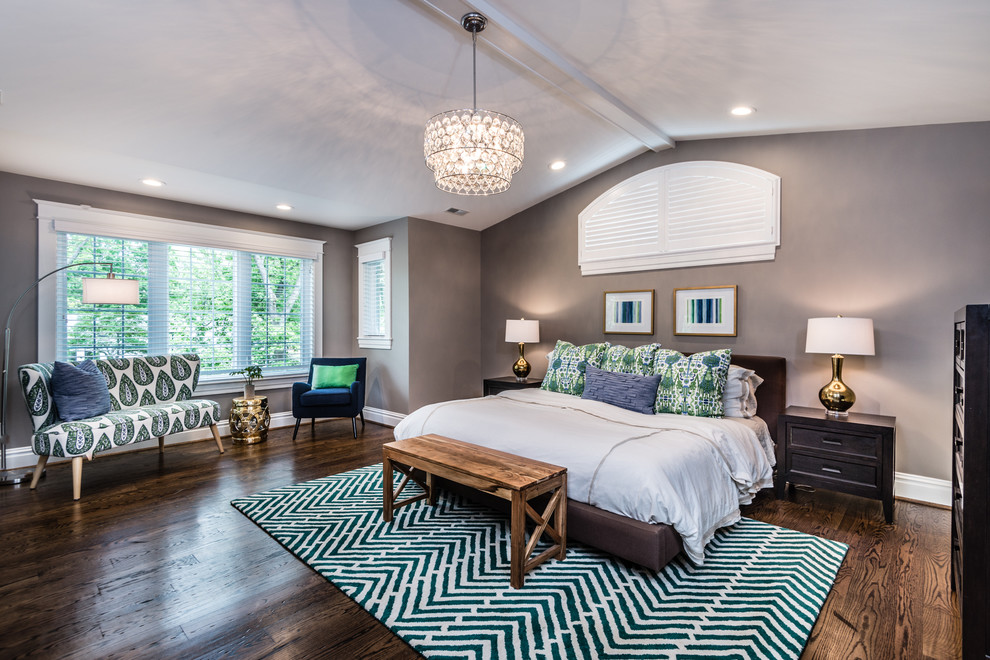This is an example of a large classic master bedroom in St Louis with grey walls and medium hardwood flooring.
