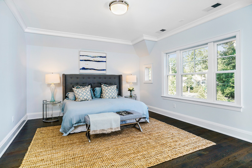 Inspiration for an expansive classic guest bedroom in New York with blue walls and medium hardwood flooring.