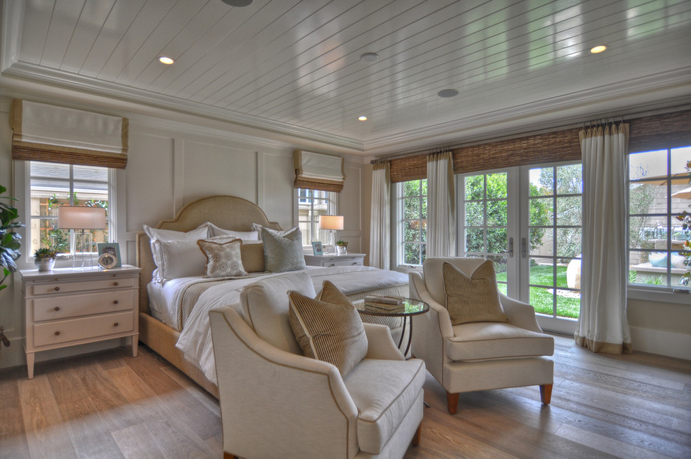 Bedroom - coastal light wood floor bedroom idea in Los Angeles with white walls