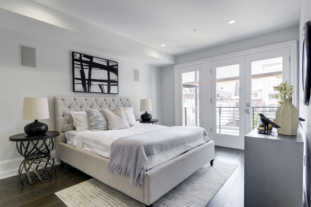 Traditional grey and brown bedroom in DC Metro with white walls, dark hardwood flooring and brown floors.