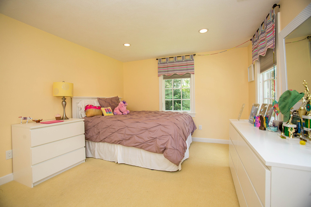 Imagen de habitación de invitados tradicional renovada con paredes amarillas y moqueta