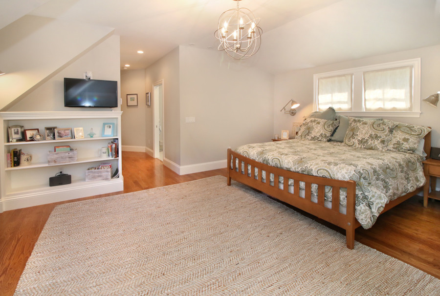 Large elegant master medium tone wood floor bedroom photo in Boston with gray walls