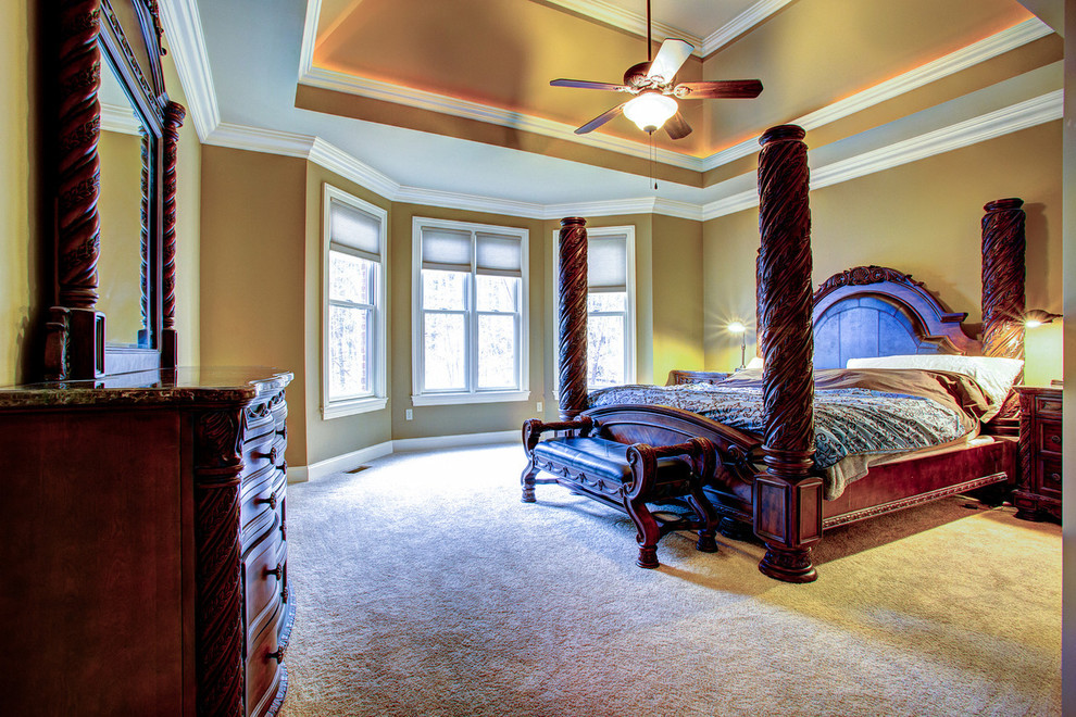 Design ideas for a large traditional master bedroom in Other with brown walls, carpet and no fireplace.