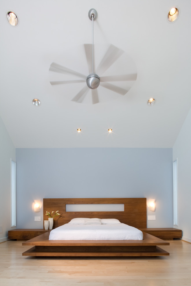This is an example of a modern bedroom in DC Metro with white walls and a feature wall.