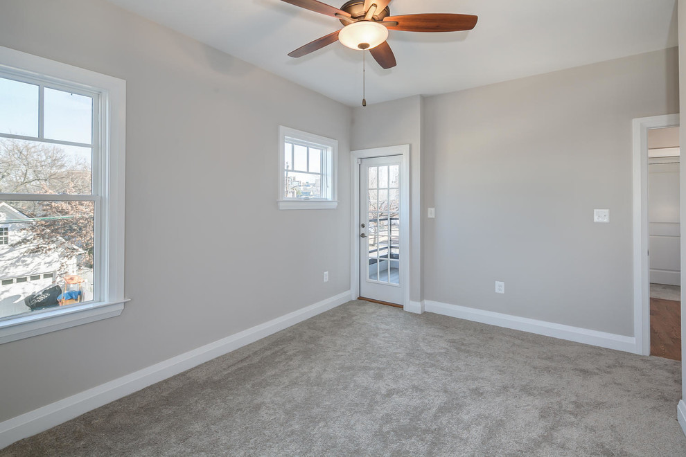Example of a guest carpeted bedroom design in DC Metro with gray walls