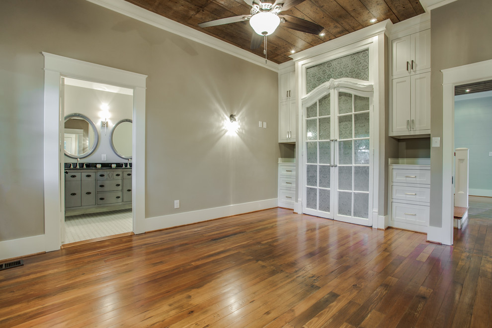 Mid-sized arts and crafts master medium tone wood floor bedroom photo in Dallas with gray walls and no fireplace
