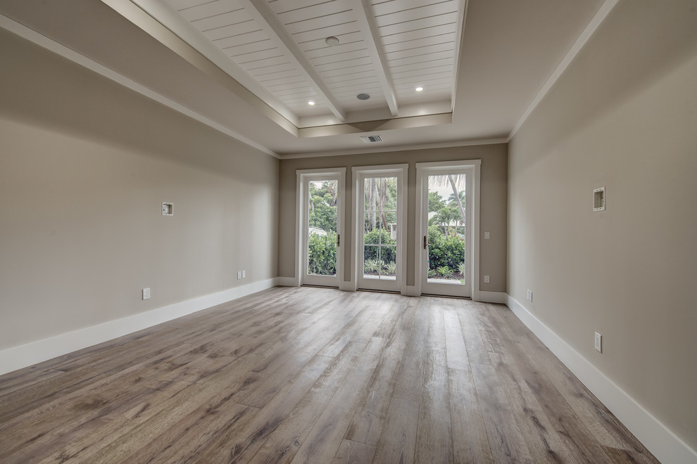 Large classic master bedroom in Other with grey walls, light hardwood flooring and no fireplace.