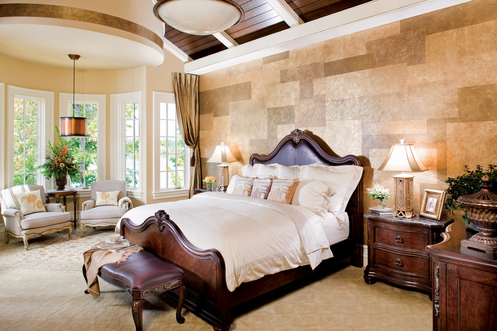 This is an example of an expansive mediterranean master bedroom in Indianapolis with beige walls and carpet.