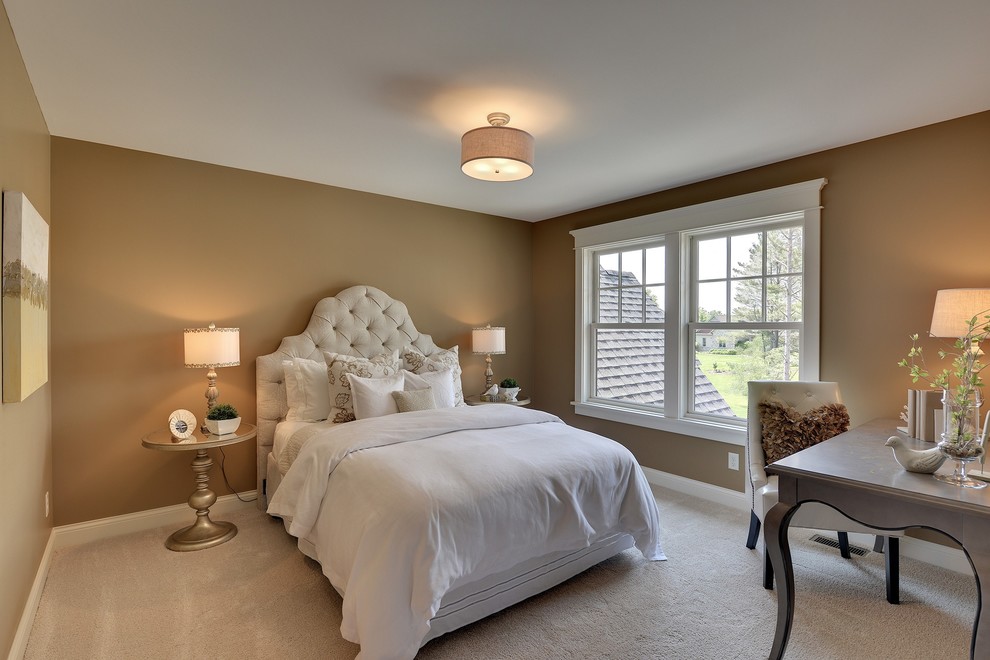 This is an example of a traditional bedroom in Minneapolis with beige walls and carpet.