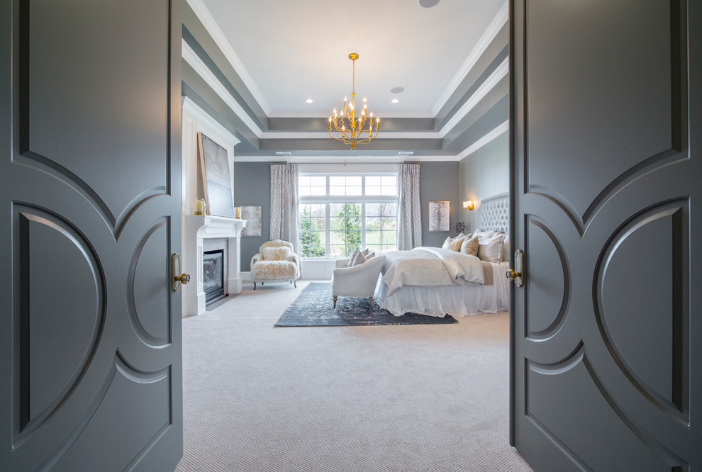 Imagen de dormitorio principal clásico renovado grande con paredes grises, moqueta, todas las chimeneas y marco de chimenea de madera
