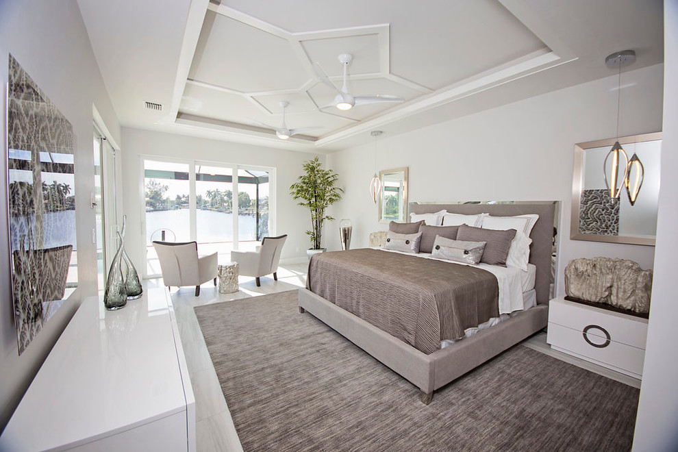 Large minimalist master carpeted bedroom photo in Miami with white walls