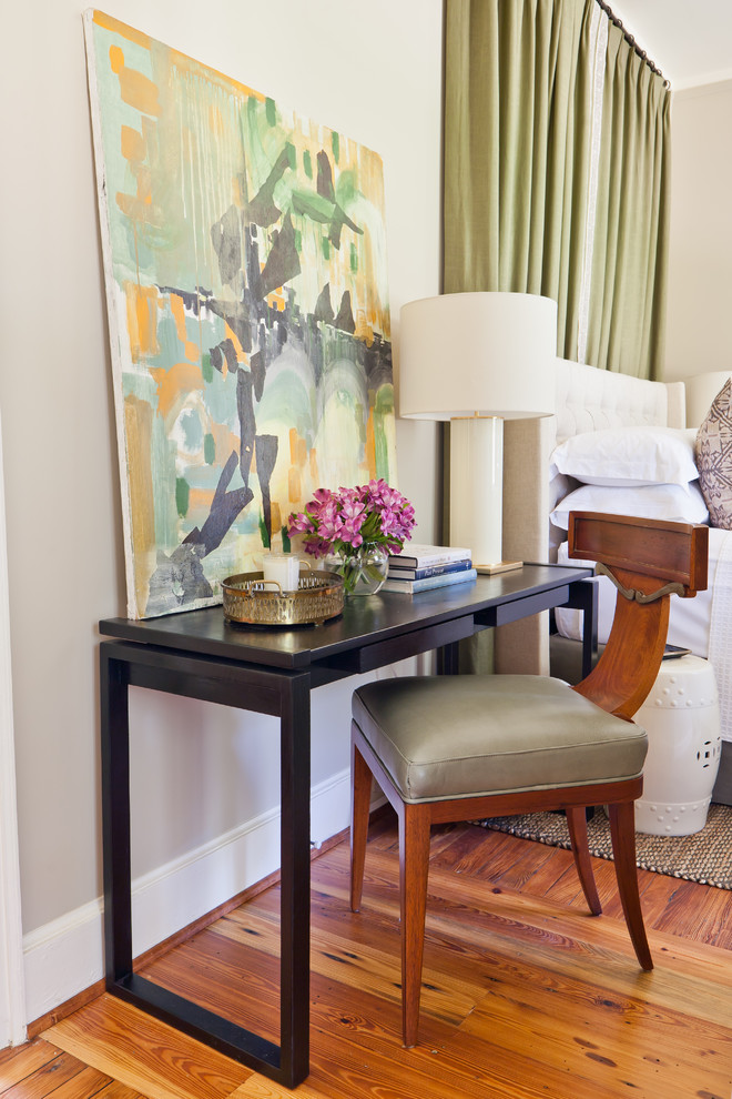 Small transitional guest medium tone wood floor and orange floor bedroom photo in Atlanta with beige walls