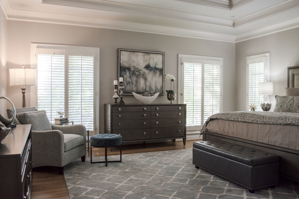 Large classic master and grey and silver bedroom in Louisville with grey walls, medium hardwood flooring, no fireplace and orange floors.