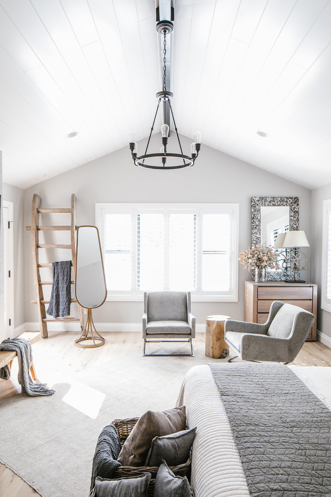 Farmhouse master bedroom in Seattle with grey walls, light hardwood flooring and beige floors.