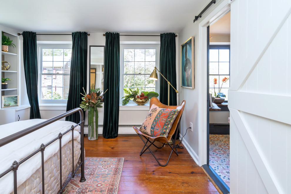 Medium sized country master bedroom in Philadelphia with green walls, medium hardwood flooring and brown floors.