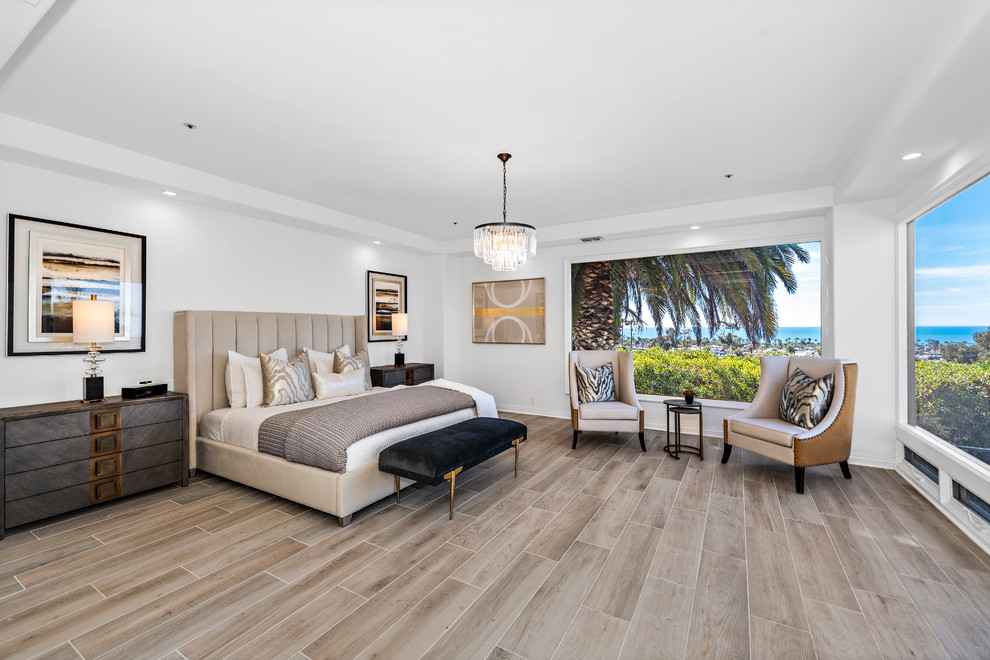 Trendy light wood floor and beige floor bedroom photo in Orange County with white walls