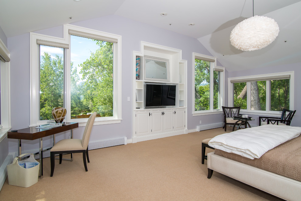 Large contemporary master bedroom in Denver with purple walls, carpet and beige floors.