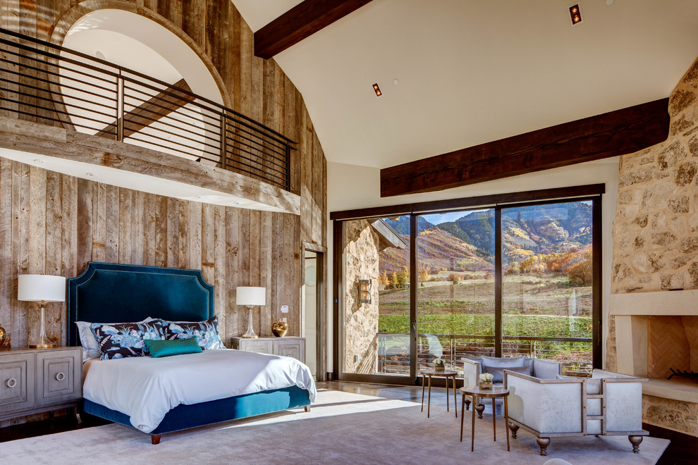 Expansive traditional master bedroom in Salt Lake City with beige walls, dark hardwood flooring, a standard fireplace and a plastered fireplace surround.