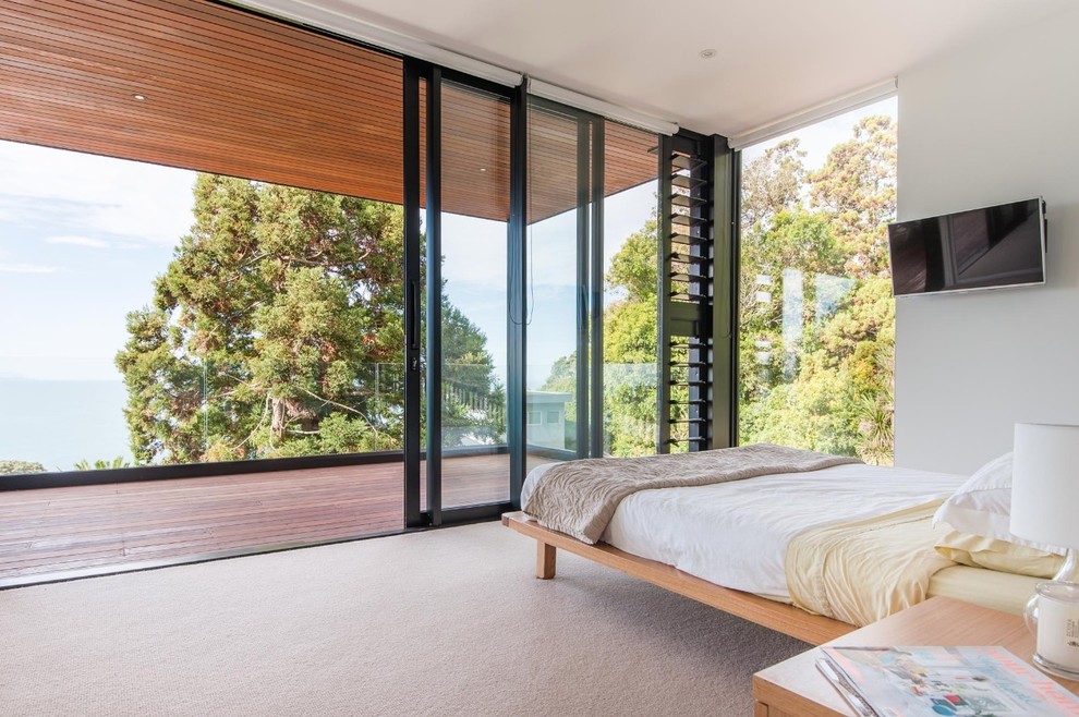 Contemporary guest bedroom in Auckland with white walls.