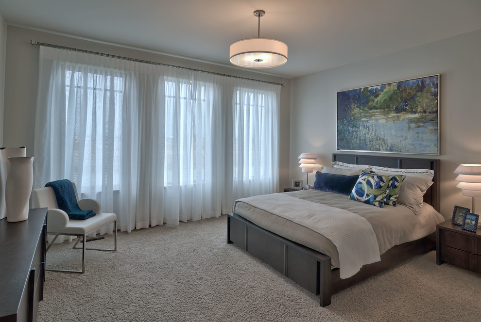 Large contemporary master and grey and cream bedroom in Other with carpet.