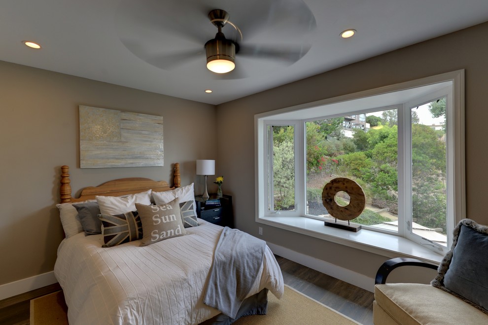 Large classic guest bedroom in Orange County with grey walls.